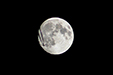 Overflying plane going through the full moon