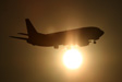 Arriving plane in Athens airport going through the afternoon sun